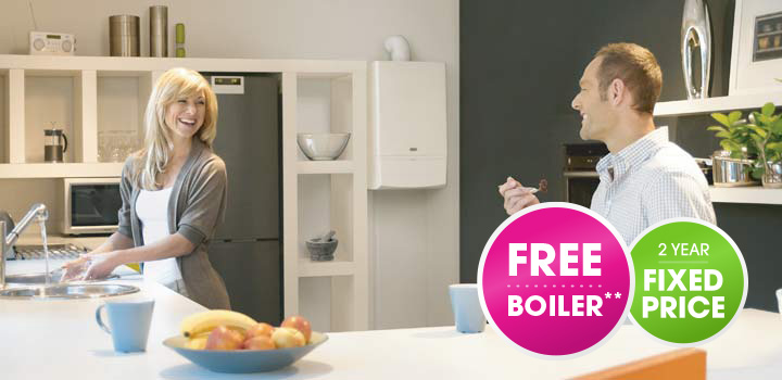 man and woman in cosy kitchen with badges about free boiler and fixed prices offer